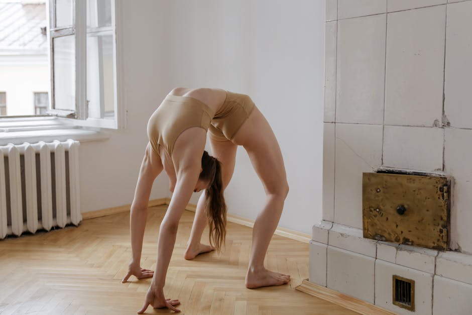 Woman gently stretching on a yoga mat in a light-filled spacious room